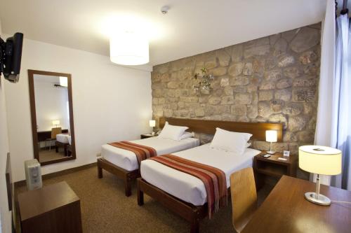 Postel nebo postele na pokoji v ubytování Tierra Viva Cusco Saphi Hotel