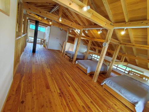 a room with three bunk beds and a wooden floor at Kikori House｜本物の素材にこだわった山村の一軒家 in Minamiaizu