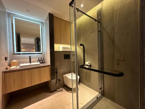 a bathroom with a shower and a toilet and a sink at La Green Hotel and Residence in Bang Tao Beach
