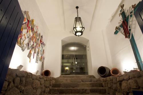 a staircase in a building with a pendant light at Tierra Viva Cusco Saphi Hotel in Cusco