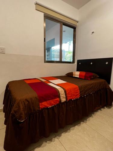 um quarto com uma cama grande e uma janela em Habitación independiente al Norte de Mérida em Mérida
