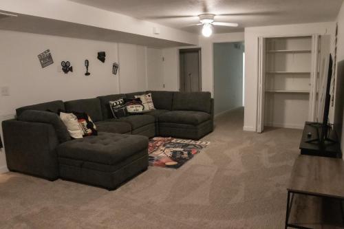a living room with a couch and a tv at Hyde Park Haven - your home away from home - minutes north of Logan and USU in Hyde Park
