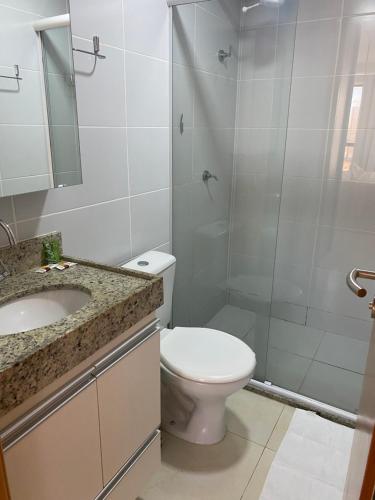 a bathroom with a toilet and a shower and a sink at MANAÍRA APART HOTEL in João Pessoa
