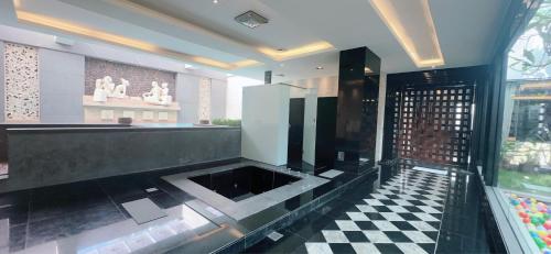 a bathroom with a black and white checkered floor at Orient Luxury Villa Motel in Huwei