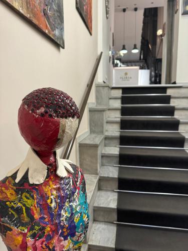 a mannequin is standing in front of a set of stairs at Hotel Ilisia in Thessaloniki