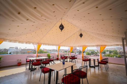 a restaurant with tables and chairs under a tent at Raj Residency in Jodhpur