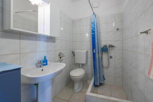a bathroom with a toilet and a sink and a shower at Apartment Perka - peaceful in Vrboska