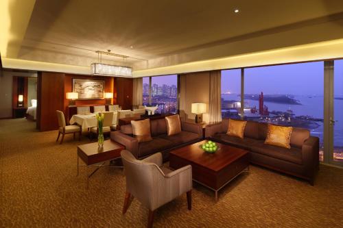 a living room with a couch and a table at Hilton Nanjing Riverside in Nanjing