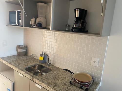 a kitchen with a sink and a counter top at MANAÍRA APART HOTEL in João Pessoa