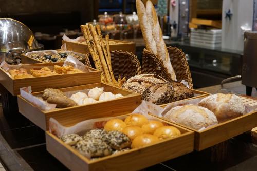 a display of different types of bread and pastries at InterContinental Shanghai Expo, an IHG Hotel in Shanghai