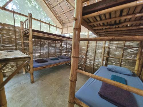 a room with two bunk beds in a tree house at SunBoo Beach Bungalows in Koh Rong Sanloem