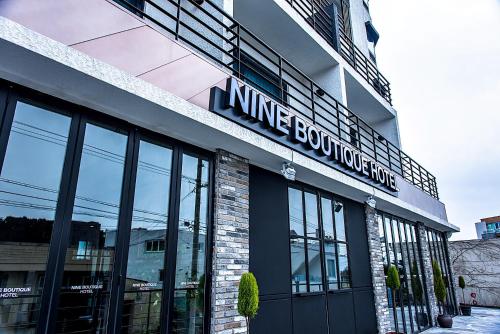 a building with a sign on the side of it at Nine Boutique Hotel in Seogwipo