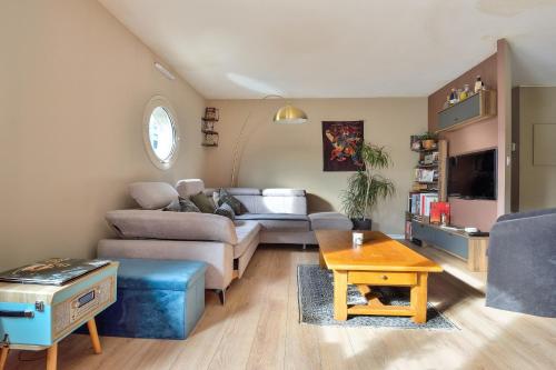 a living room with a couch and a table at T3 with balcony near the Stade de France - Welkeys in Saint-Denis