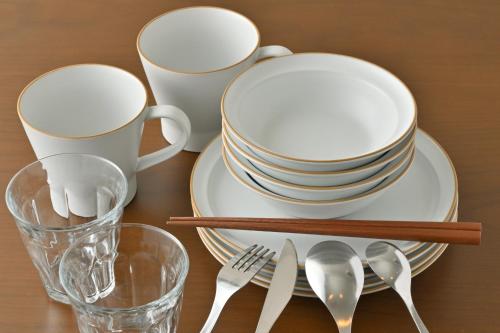 a table with plates and utensils on a table at GRAND BASE Hiroshima Peace Memorial Park in Hiroshima