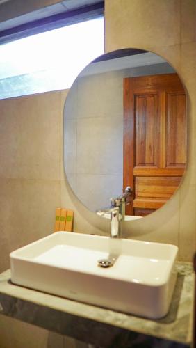 a bathroom with a sink and a mirror at KTM Resort Batam in Sekupang