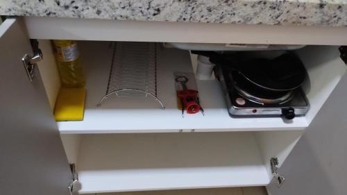 a kitchen cabinet drawer with a kitchen utensils at MANAÍRA APART HOTEL in João Pessoa