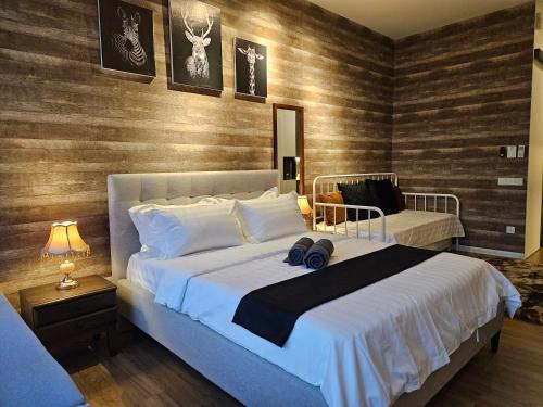 a bedroom with a large white bed and wooden walls at Romantic Log Cabin 3 - in the Heart of KL city (walk to KL Tower/KLCC/Bukit Bintang) in Kuala Lumpur