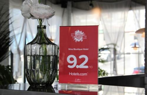 a vase with a flower in it on a table at Nine Boutique Hotel in Seogwipo