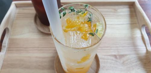 a glass with oranges in it sitting on a table at Nine Boutique Hotel in Seogwipo