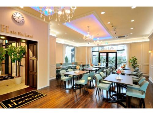 un restaurante con mesas y sillas y un reloj en la pared en Grand Park Hotel Panex Hachinohe / Vacation STAY 77784, en Hachinohe