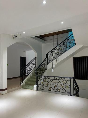 a staircase in a house with a chandelier at SUBINH HOTEL AND RESTAURANT in Pakse