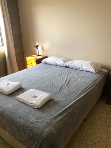a bed with two towels on it in a bedroom at Unit 4 Pattison in Emu Park