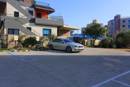 a car parked in a parking lot next to a building at Nine Boutique Hotel in Seogwipo