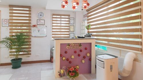 a kitchen with a christmas display on the wall at Catlea Inn in Manila