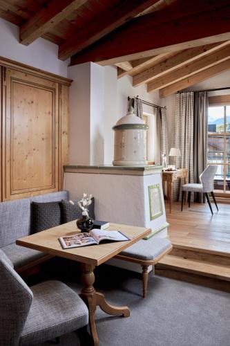 a living room with a table and chairs at Hotel Gletscherblick in Sankt Anton am Arlberg
