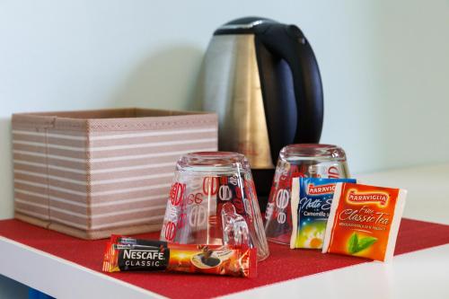 a counter top with two cans of snacks and a kettle at Casa Vittoria di San Martino Affittacamere in Genova