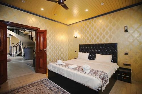 a bedroom with a large bed in a room at The GoodFind Residency in Srinagar