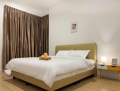 a bedroom with a bed with a teddy bear on it at Taiping City View Condo near Lake Garden/ Netflix in Taiping