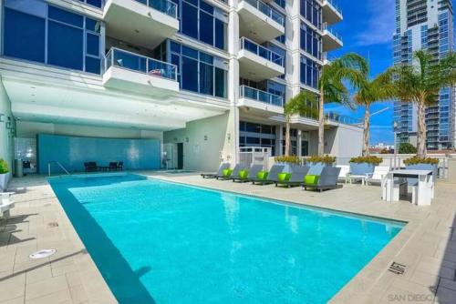 a swimming pool in front of a building at 2BR Hi-Rise Condo in Gaslamp SD in San Diego
