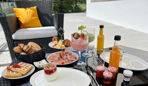 a table with plates of food and bottles of wine at Guesthouse St Nikolaus in Ultimo