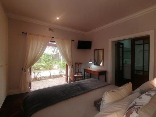 a bedroom with a large bed and a window at Beulah Lodge in Cape Town