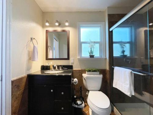 a bathroom with a toilet and a sink and a mirror at 839-Sunnyvale Great location 2Br/2Bth unit/Kingbed in Sunnyvale