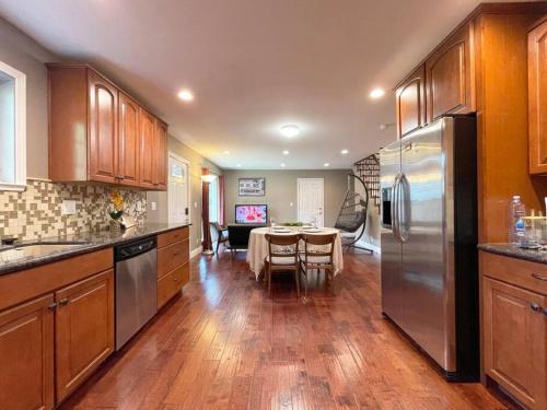 a kitchen with a table and a stainless steel refrigerator at 839-Sunnyvale Great location 2Br/2Bth unit/Kingbed in Sunnyvale
