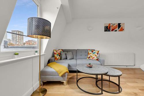 a living room with a couch and a table at Contemporary Oasis in Paddington III in London