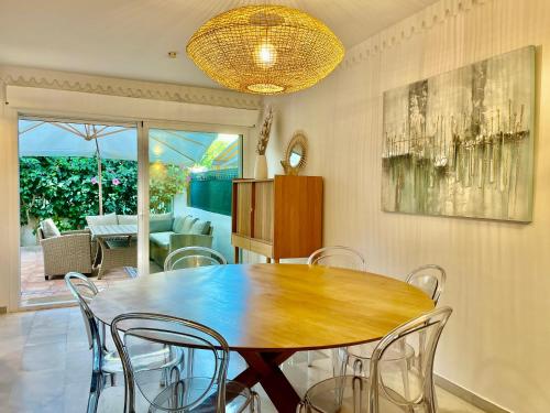 a dining room with a wooden table and chairs at Marbella Trocadero Beach & Pool in Marbella