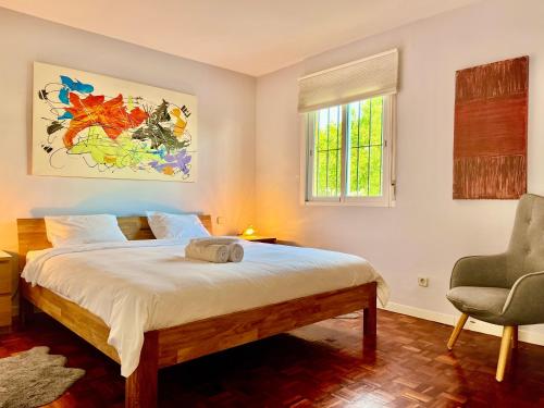 a bedroom with a bed and a chair and a window at Marbella Trocadero Beach & Pool in Marbella