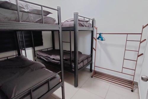 a room with three bunk beds in a room at Biubiu Home in Melaka