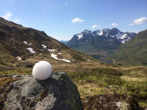 a golf ball sitting on top of a rock on a mountain at Gammelstua Seaview Lodge in Kongsjorda