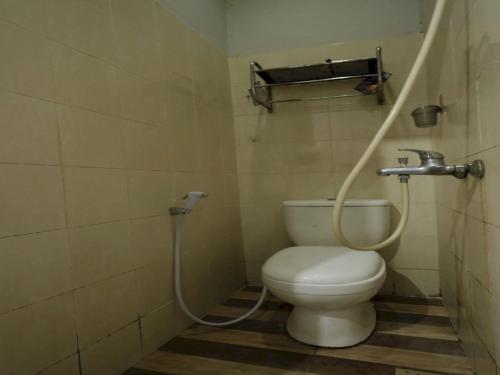 a bathroom with a toilet and a shower in it at SPOT ON 93276 Fendi 2 Homestay Syariah in Nagoya