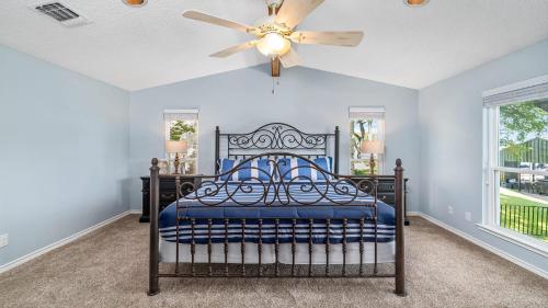 a bedroom with a bed and a ceiling fan at Waterfront House with Amazing Outdoor Oasis Boat Slip and Pet Friendly in Kingsland