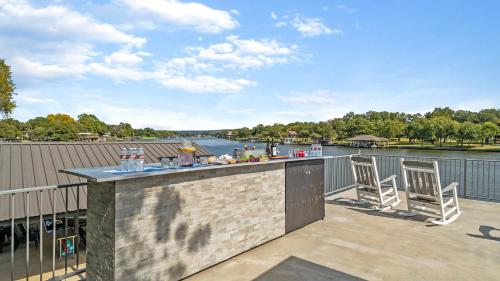 a bar on a balcony with a view of a river at Waterfront House with Amazing Outdoor Oasis Boat Slip and Pet Friendly in Kingsland