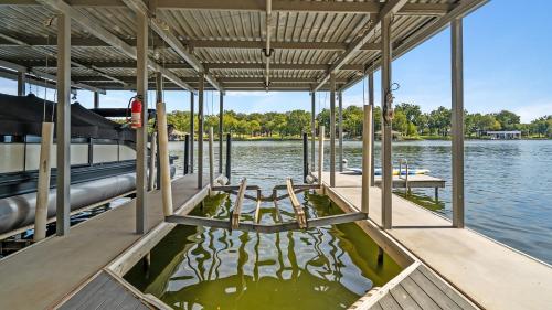a boat dock with a picnic table on the water at Waterfront House with Amazing Outdoor Oasis Boat Slip and Pet Friendly in Kingsland
