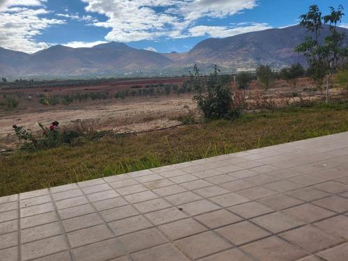 a walkway with a view of a field and mountains at Ferme Jnan Al Yassmine in Taza