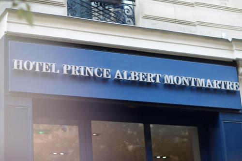 a sign on the front of a hotel entrance adjacent to a building at Prince Albert Montmartre in Paris