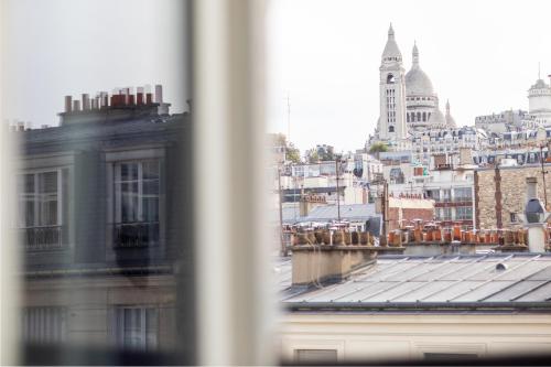 a view of a city from a window at Prince Albert Montmartre in Paris