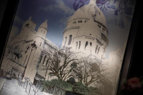 a picture of a white building with a tree at Prince Albert Montmartre in Paris
